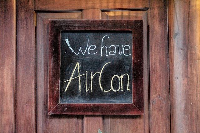 a chalk board saying "we have aircon"